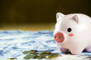 Inserting a coin into a piggy bank